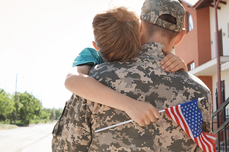 American Soldier Hugging With His Son Outdoors. Military Service